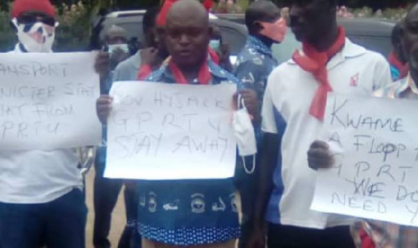 A photo of demonstrators holding placards