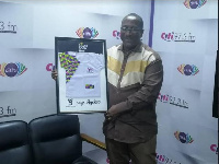 CEO of Citi FM displays the Do Ghana Good campaign plaque