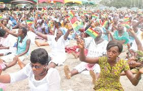 File photo of women praying at AGLOW for Christ event.