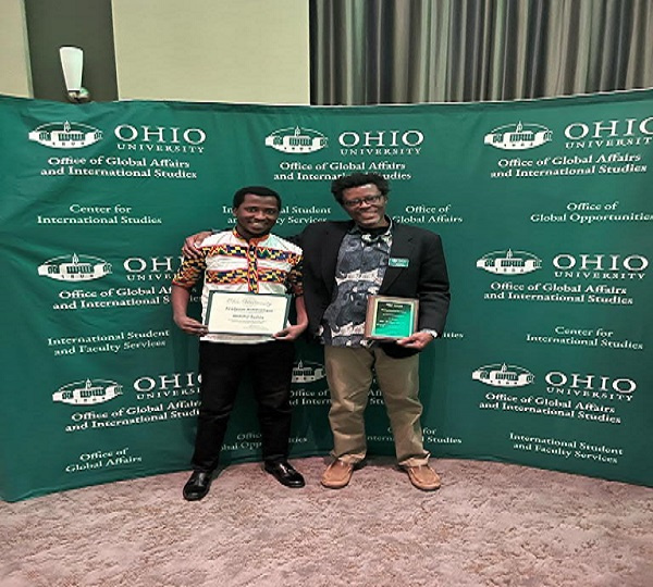 Abubakar Bashiru displaying his award