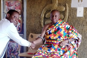 Nana Akwasi Bosomprah, the Paramount Chief of Goaso Traditional Area greets a visitor