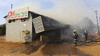 Firefighters extinguish a fire at a supermarket in Manzini, Eswatini