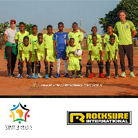 Yasmin Behzadi left, with the young players of Urban Africa Youth Academy and their coach