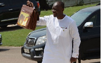 Ken Ofori-Atta holding high the bag containing the legendary budget statement