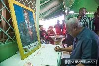 Former President John Mahama signing the book of condolence