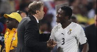 A photo of Asamoah Gyan and Milovan Rajevac