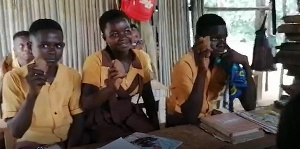 A picture of some pupils holding the stone they use as the computer mouse