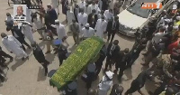 Before Amadou Gon Coulibaly's burial, relatives surrounded his remains and prayed for him