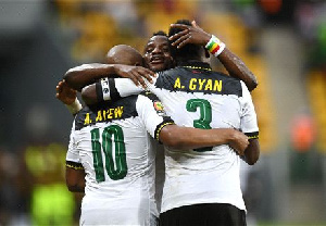 Wakaso embraces Ayew and Asamoah Gyan after they take the lead