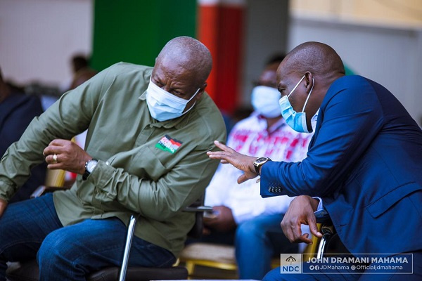 John Mahama confers with Haruna Iddrisu at a gathering