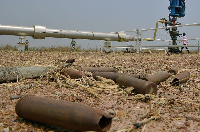 Spent munitions lie on the ground at an abandoned oil treatment facility in Unity State, South Sudan