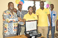 Mr Isaac Okyere (left) receiving one of the computers from Ms Mercy Quansah Ansah