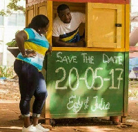 The would be couple is spotted in a kiosk painted with the  Ghanaian national colours