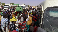 File photo: Migrants at a bus station