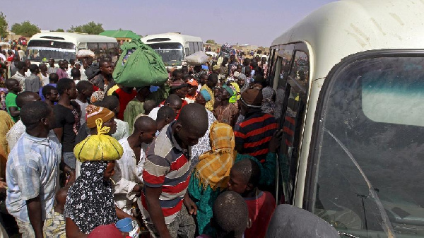 File photo: Migrants at a bus station