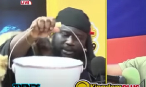 Bishop Kwabena Asiamah popularly known as 'Ajagurajah' holding a metal bucket during an interview