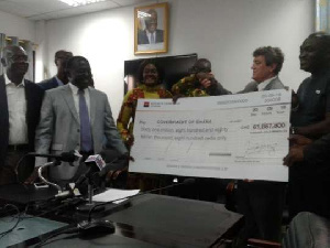 Adriano Sobreira presented the cheque to the Minister of Lands and Natural Resources