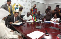 Finance Minister, Ken Ofori-Atta signing the deal with the delegates fro Kuwait