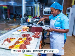 Faila dishing out food from one of the pots