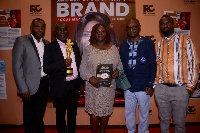 Ernest Poku, Facility Manager Afriwave (2nd left), displaying the award with other staff members