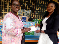 Doris Vidda, Director of Akwaaba Zorg Inc. (l) donating some items to the Osu Children's Home