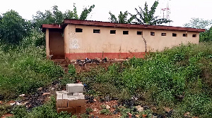 A photograph of the dilapidated toilet facility