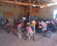 The students studying under a dilapidated building