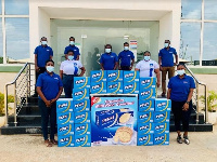 Staff of Nutrifoods Ghana pose with samples of Perk Milkrich Biscuits