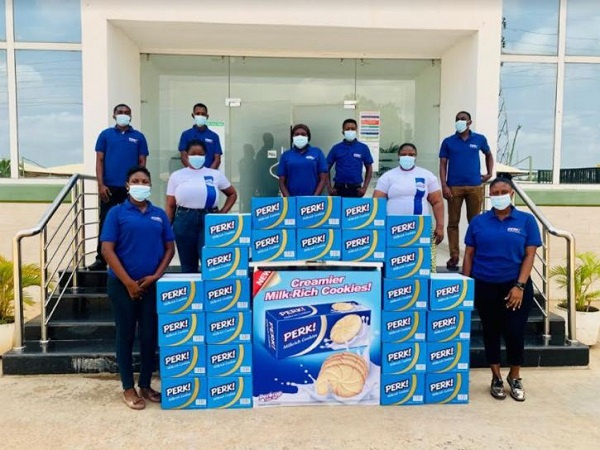 Staff of Nutrifoods Ghana pose with samples of Perk Milkrich Biscuits