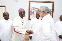 Former President of Ghana, J.J Rawlings in a handshake with Most Reverend John Bonaventure Kwofie