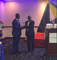 Dr. Akwasi  Achampong (left) receives the award