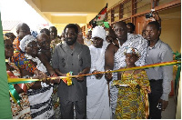 Dr. Okoe Vanderpuije cuts ribbon at 17th Millennium City School commissioning.