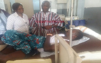 Hassan Tampuli with some staff and fire victims at the hospital