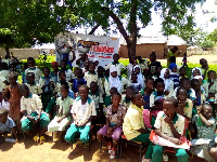 A photograph of some pupil sitting under a tree