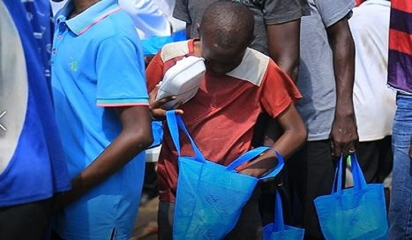 A photo of a beneficiary holding his food