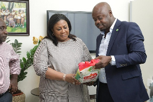 First Lady Rebecca Akufo-Addo inspecting a bag of local rice during the meeting