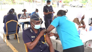 A custom officer receiving the jab