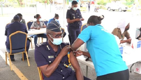 A custom officer receiving the jab