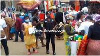 Police personnel enforcing mask wearing in the market