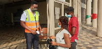 A security officer inspects vaccination cards