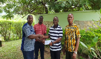 Adongo Ayamga presenting the money to Paul Asare Ansah