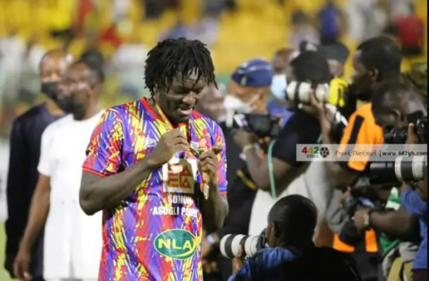 Sulley Muntari admires his President's Cup winner's medal