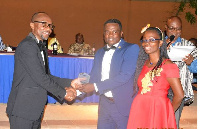 Mr Kwabena Ofosu Appiah (left) immediate past President of GIFF presenting the award to Mr Terrison