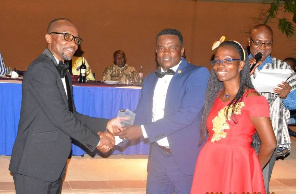 Mr Kwabena Ofosu Appiah (left) immediate past President of GIFF presenting the award to Mr Terrison