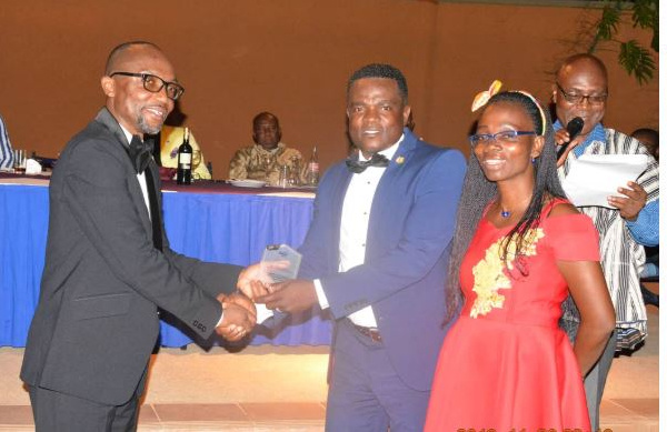 Mr Kwabena Ofosu Appiah (left) immediate past President of GIFF presenting the award to Mr Terrison