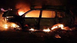 The Toyota Highlander in flames after it crashed