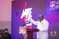 President Akufo-Addo holding a copy of the NPP's 2020 manifesto