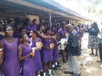 The students receiving the Bibles from the delegation