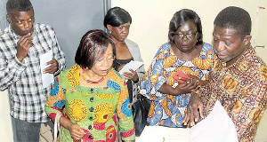 Dr AA Appiah showing the AMMREN team documented plants from the herbarium