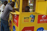 A Mobile Money agent serving clients